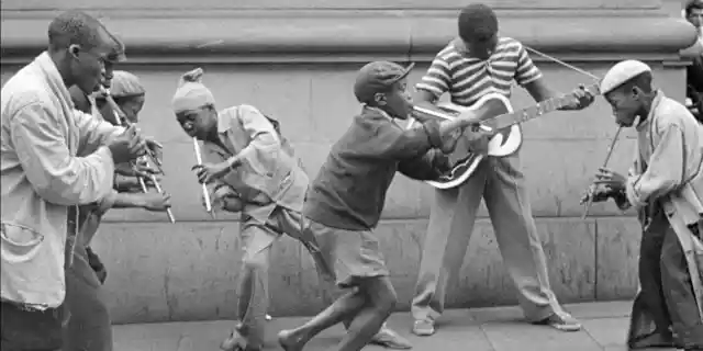 Penny Whistlers and Musicians on the street in the film COME BACK, AFRICA by Lionel Rogosin. The South African anti-apartheid classic from 1959 is a Milestone Film &amp;amp; Video release. Restored by the Cineteca di Bologna and the laboratory L’Imagine Ritrovata with the collaboration of Rogosin Heritage and the Anthology Film Archives.