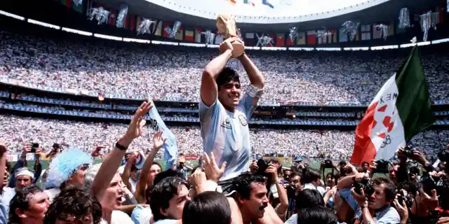 Volume 2, Page 13, Picture 4, 10234981, Sport, Football, 1986, World Cup Final, (Mexico City), Argentina Captain, Diego Maradona holds the World Cup trophy whilst being carried on his team-mates&#039; shoulders  (Photo by Bob Thomas/Getty Images)